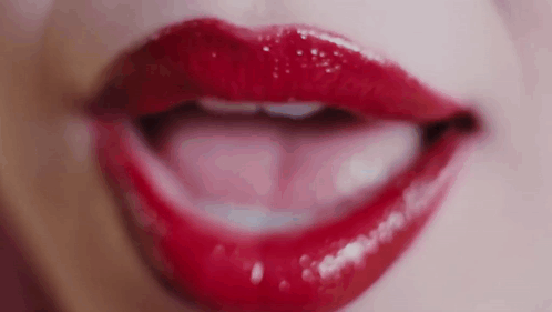 a close up of a woman 's lips with red lipstick on them .