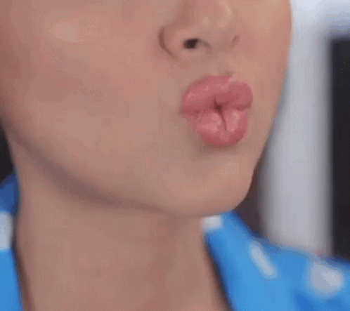 A Close Up Of A Woman 'S Mouth With Her Tongue Hanging Out . GIF