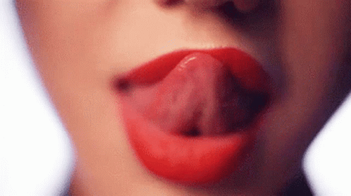 A Close Up Of A Woman 'S Mouth With Her Tongue Sticking Out . GIF
