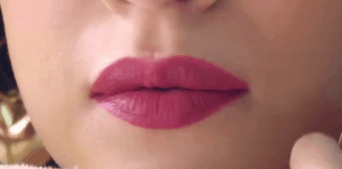 A Close Up Of A Woman 'S Mouth With Pink Lipstick . GIF