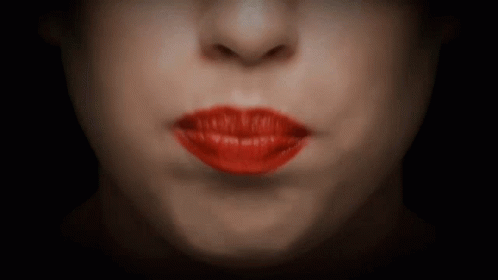 A Close Up Of A Woman 'S Mouth With Red Lips GIF