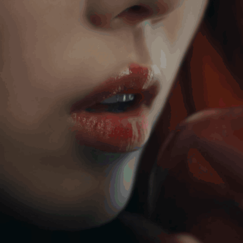 A Close Up Of A Woman 'S Mouth With Red Lipstick GIF