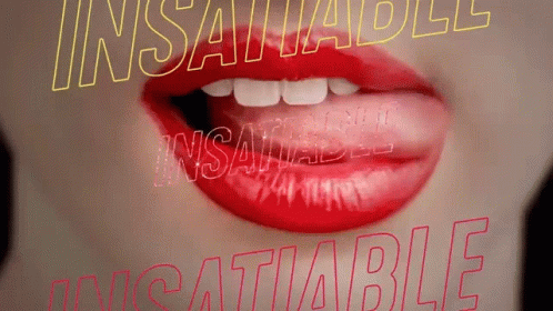 A Close Up Of A Woman 'S Mouth With Red Lipstick And The Words Insatiable And Insatiable Behind Her GIF