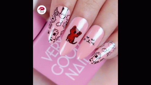 A Close Up Of A Woman 'S Nails With A Cat Design GIF