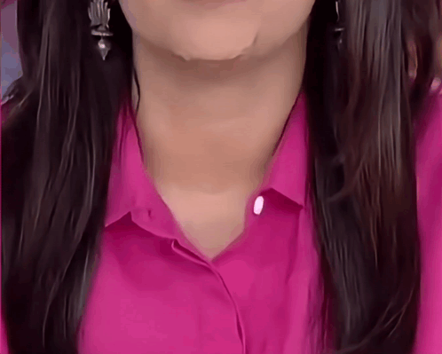 A Close Up Of A Woman 'S Neck And Neckline In A Pink Shirt GIF