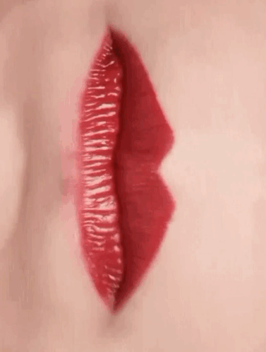A Close Up Of A Woman 'S Red Lips With Red Lipstick . GIF