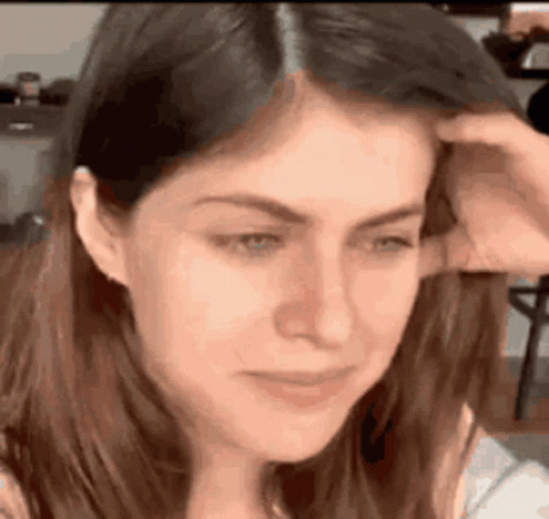 A Close Up Of A Woman Scratching Her Head . GIF