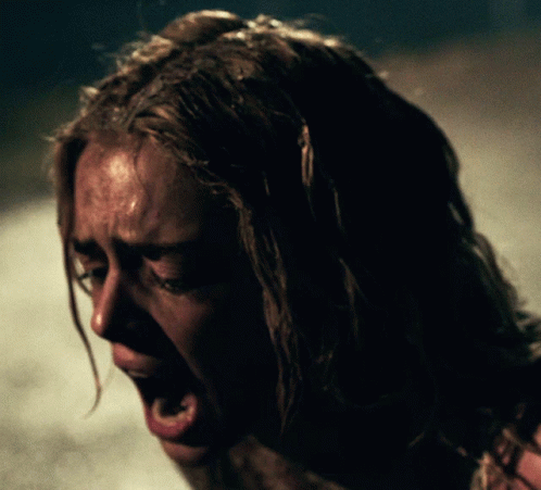 A Close Up Of A Woman Screaming With Her Mouth Wide Open GIF