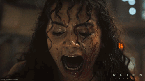 A Close Up Of A Woman Screaming With The Words Alien Romulus On The Bottom Right GIF