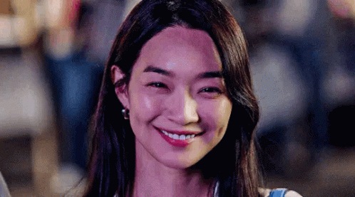 A Close Up Of A Woman Smiling With Her Eyes Closed . GIF