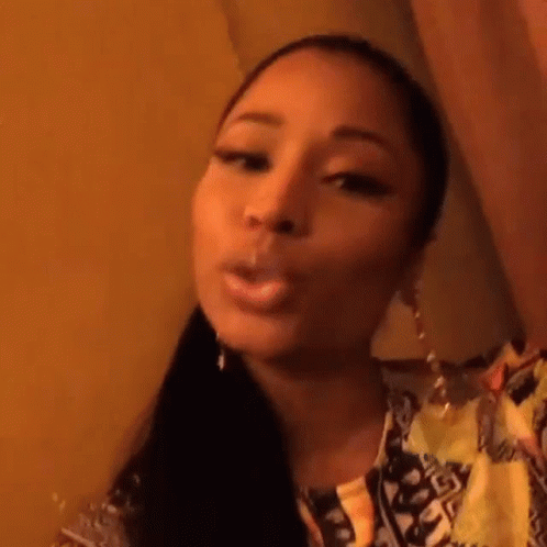 A Close Up Of A Woman Smoking A Cigarette While Taking A Selfie . GIF