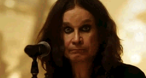 A Close Up Of A Woman Standing In Front Of A Microphone Making A Funny Face . GIF