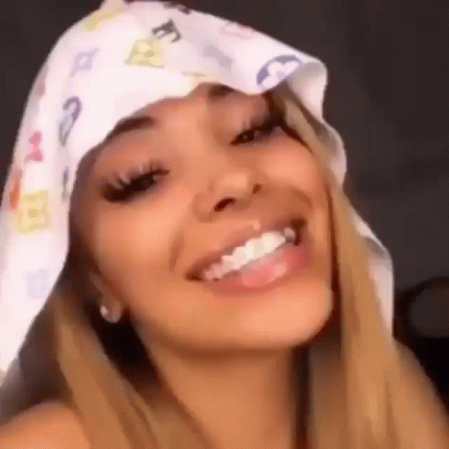 A Close Up Of A Woman Wearing A Bandana On Her Head . GIF