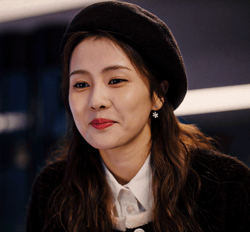 A Close Up Of A Woman Wearing A Black Beret GIF