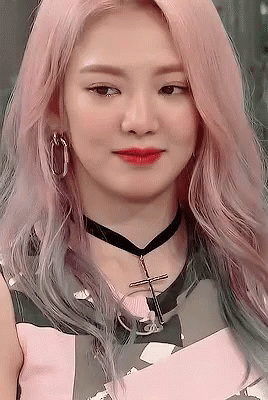 A Close Up Of A Woman Wearing A Choker And Earrings . GIF