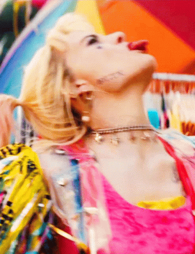 A Close Up Of A Woman Wearing A Choker And Earrings GIF