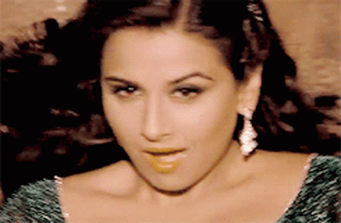 A Close Up Of A Woman Wearing A Green Dress GIF