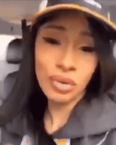 A Close Up Of A Woman Wearing A Hat And Making A Funny Face . GIF