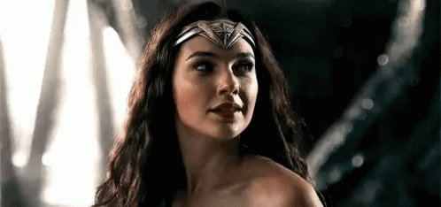 A Close Up Of A Woman Wearing A Headband And A Crown . GIF