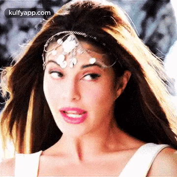 A Close Up Of A Woman Wearing A Headband On Her Forehead . GIF