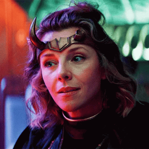 A Close Up Of A Woman Wearing A Horned Helmet . GIF