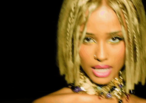 A Close Up Of A Woman Wearing A Necklace And Braids GIF