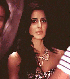 A Close Up Of A Woman Wearing A Necklace GIF