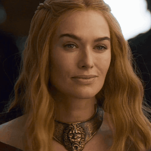 A Close Up Of A Woman Wearing A Necklace With A Lion Face On It GIF