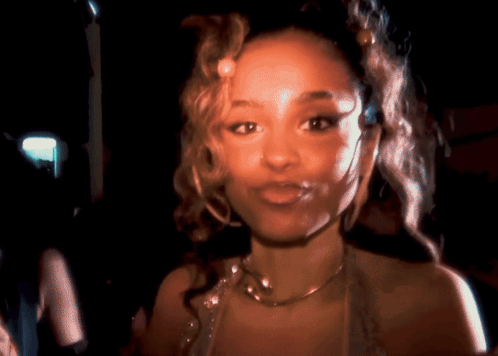A Close Up Of A Woman Wearing A Necklace GIF
