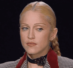 A Close Up Of A Woman Wearing A Plaid Jacket GIF