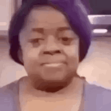 A Close Up Of A Woman Wearing A Purple Hat And A Blue Shirt . GIF