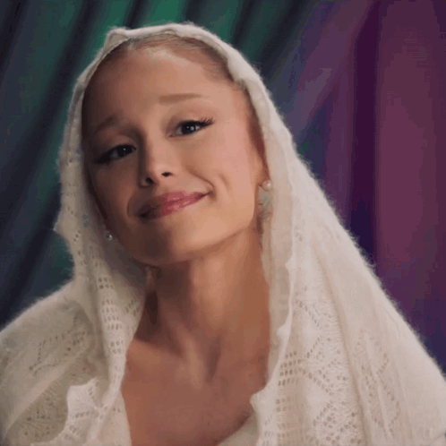 A Close Up Of A Woman Wearing A White Scarf On Her Head GIF