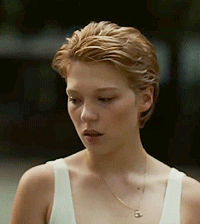 A Close Up Of A Woman Wearing A White Tank Top And Necklace GIF