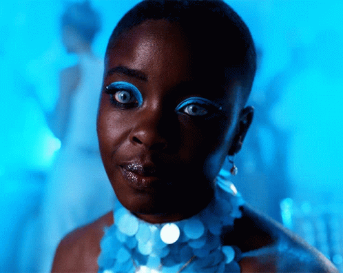 A Close Up Of A Woman Wearing Blue Eye Makeup GIF