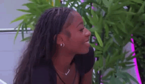 A Close Up Of A Woman Wearing Earrings And A Necklace . GIF