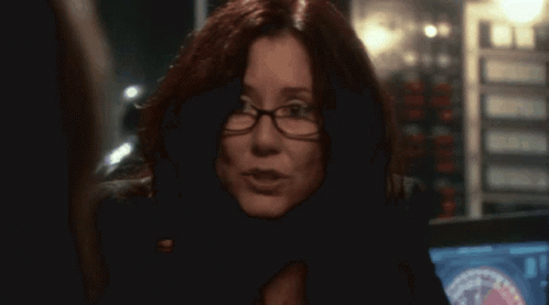 Woman Wearing Glasses And Badge Close Up GIF