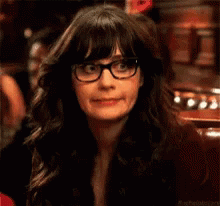 A Close Up Of A Woman Wearing Glasses And A Black Jacket . GIF