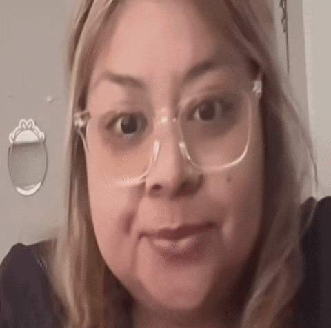 a close up of a woman wearing glasses and a black shirt .