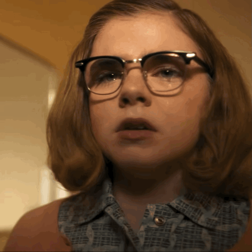 A Close Up Of A Woman Wearing Glasses And A Shirt That Says ' I Love You ' On It GIF