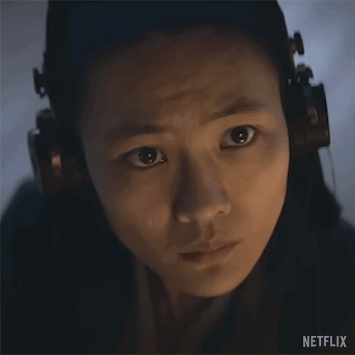 A Close Up Of A Woman Wearing Headphones With A Netflix Logo In The Corner . GIF