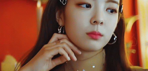 A Close Up Of A Woman Wearing Hoop Earrings And A Choker GIF