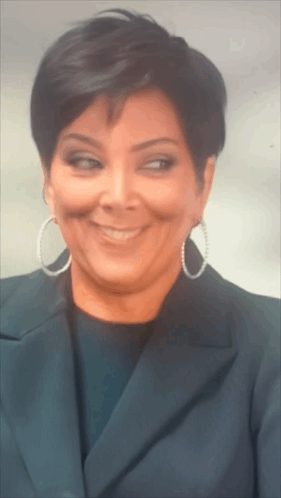 A Close Up Of A Woman Wearing Hoop Earrings GIF
