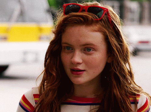A Close Up Of A Woman Wearing Red Sunglasses GIF