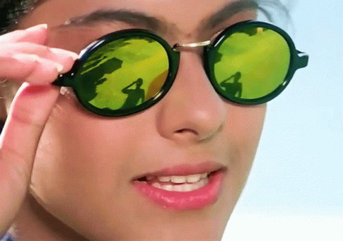 A Close Up Of A Woman Wearing Sunglasses With A Reflection Of A Person GIF