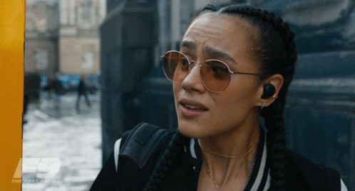 A Close Up Of A Woman Wearing Sunglasses With The Fast Saga Written On The Bottom GIF