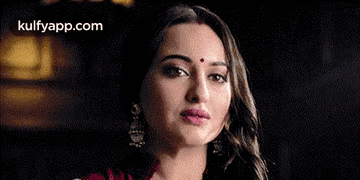 A Close Up Of A Woman With A Bindi On Her Forehead . GIF