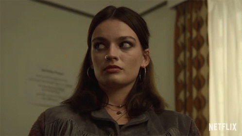 A Close Up Of A Woman With A Netflix Logo On The Bottom GIF