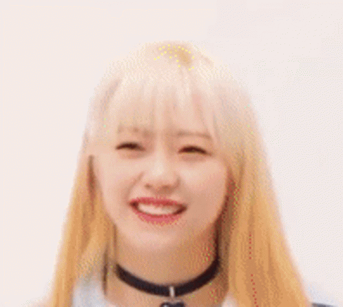 A Close Up Of A Woman With Blonde Hair And A Choker Smiling . GIF