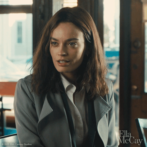 A Close Up Of A Woman With Ella Mccay Written On The Bottom Right GIF
