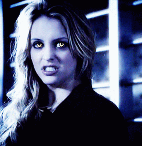 A Close Up Of A Woman With Glowing Eyes GIF